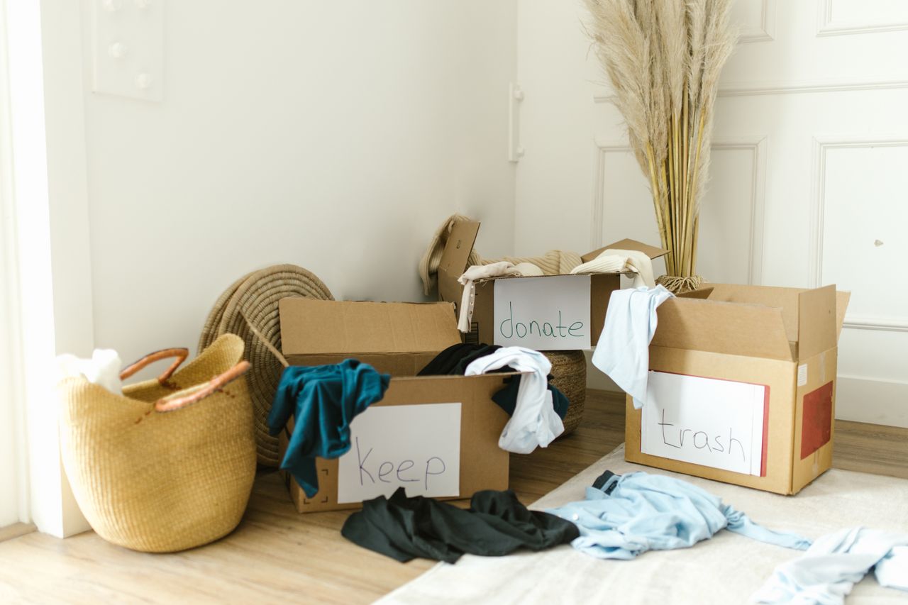 Cardboard boxes marked Keep, Donate, and Trash for home decluttering.
